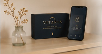 Vitaria box next to a phone with the app